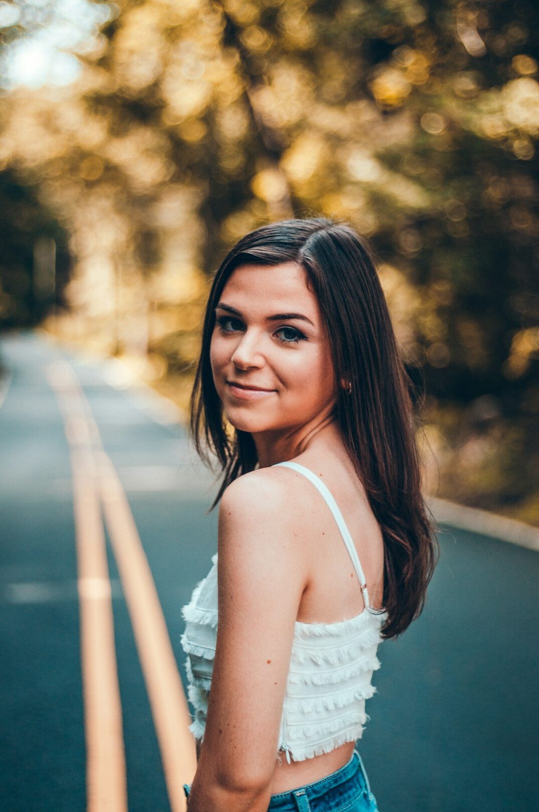 Portrait of a young woman with brown hair smiling