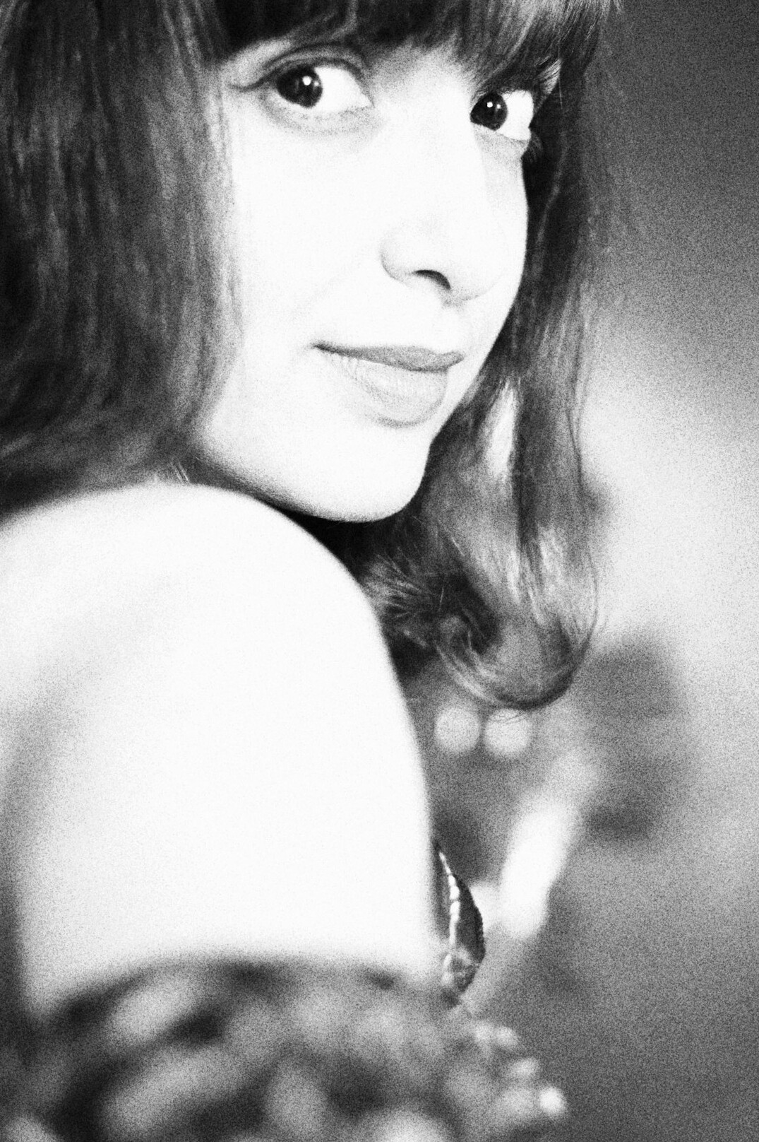 Portrait of a woman with shoulder-length hair smiling
